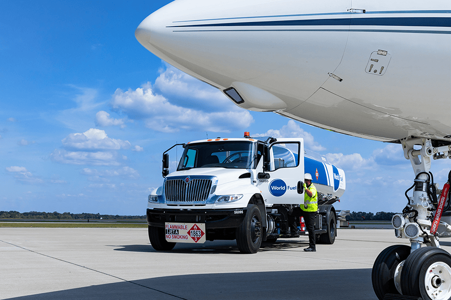 Fuel truck servicing an aircraft on tarmac