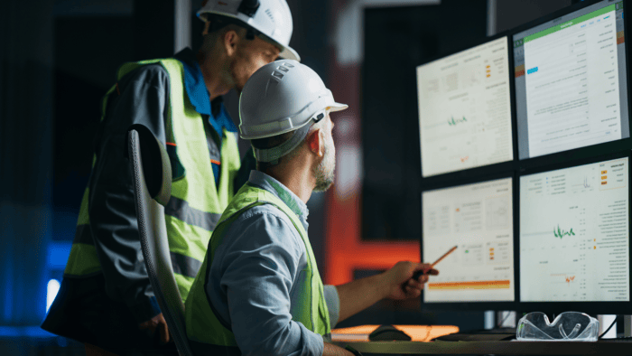 Engineers analysing data on multiple screens.
