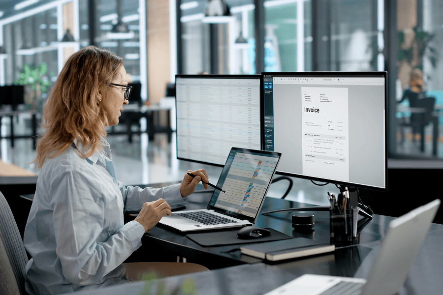 Woman working on financial documents digitally.