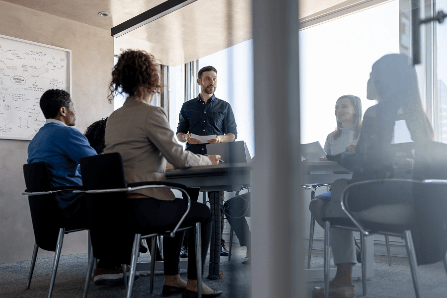 Man presenting to engaged team members