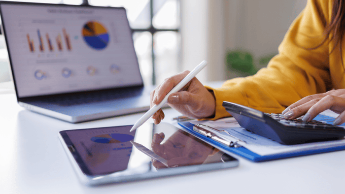 Businesswoman analysing data with technology