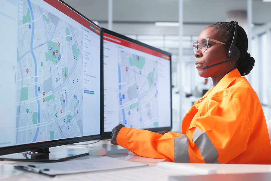Woman monitoring maps on computers
