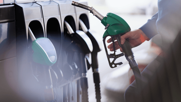 hand holding fuel dispenser nozzle