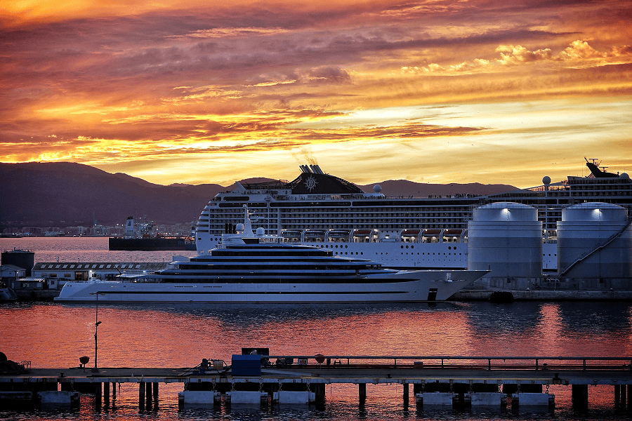 Cruise ships at sunset by harbour.
