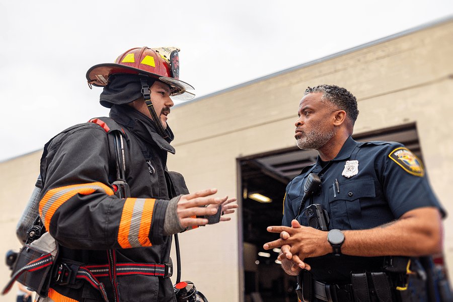 Firefighter and police officer discussing