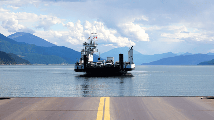 A car carrier vessel navigating coastal shipping lanes during a maritime automotive transport operation