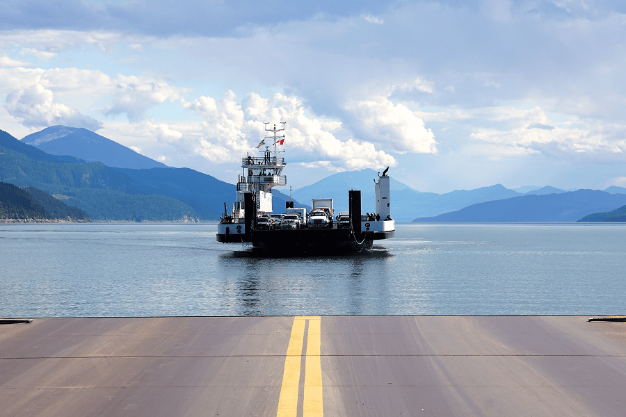A car carrier vessel navigating coastal shipping lanes during a maritime automotive transport operation