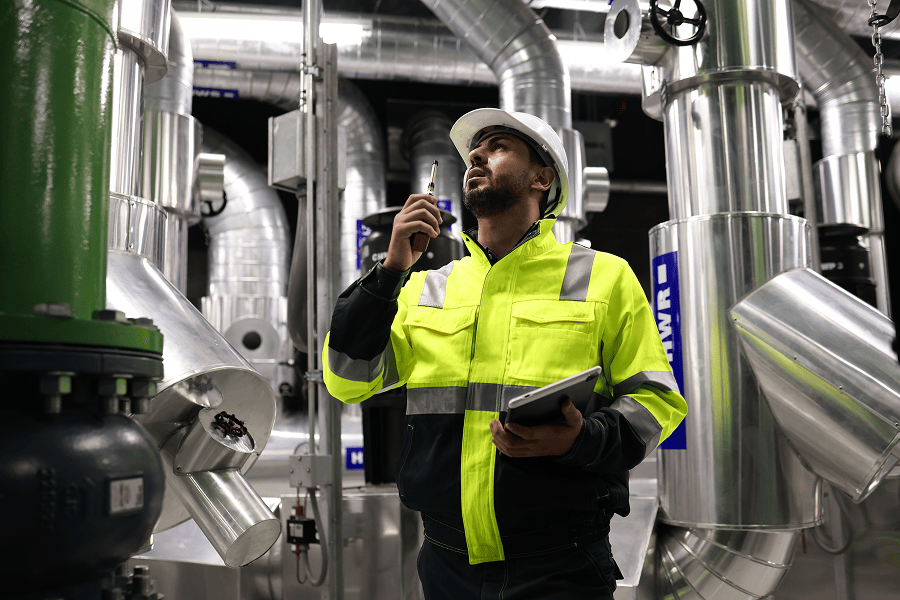 A marine engineer communicating on a walkie-talkie