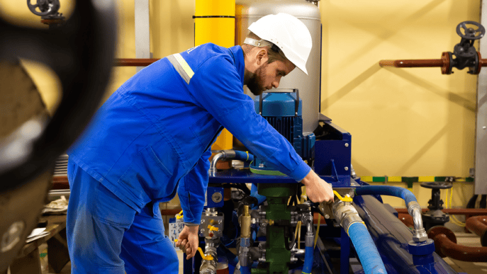 A marine industrial engineer working on equipment