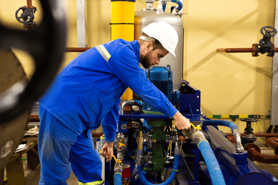 A marine industrial engineer working on equipment