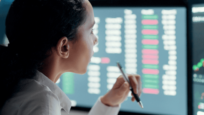 A female logistics analyst reviewing data graphs