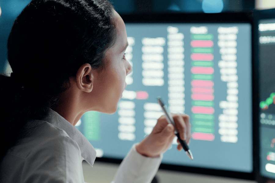 A female logistics analyst reviewing data graphs