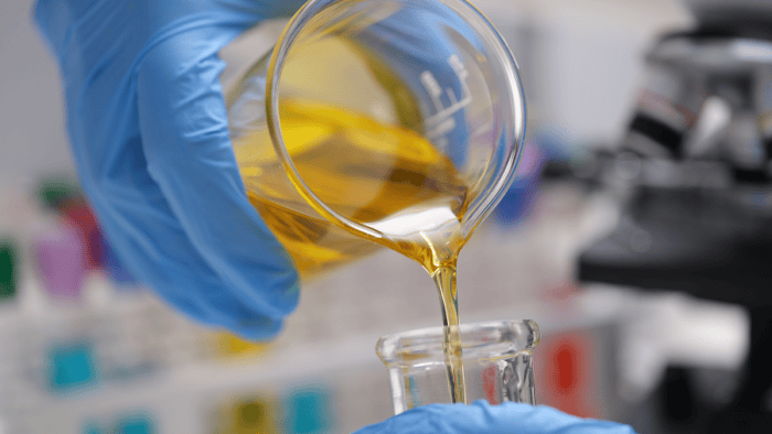 An industrial laboratory technician conducting marine fuel and oil testing