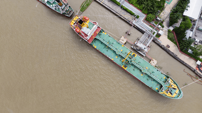 A large commercial vessel docked at a port terminal