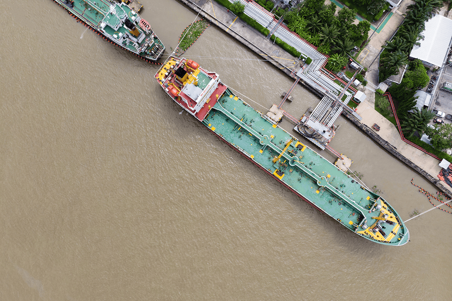 A large commercial vessel docked at a port terminal