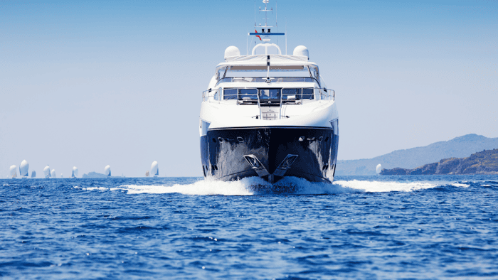 A motor yacht coming into a dock at a marina pier