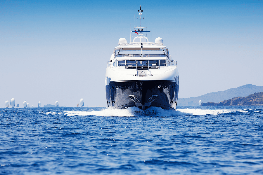 A motor yacht coming into a dock at a marina pier
