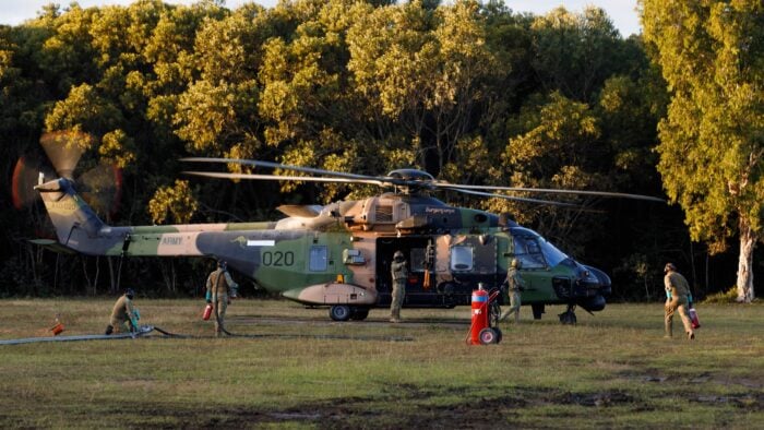 Military refueling operations being conducted on an MRH90 helicopter