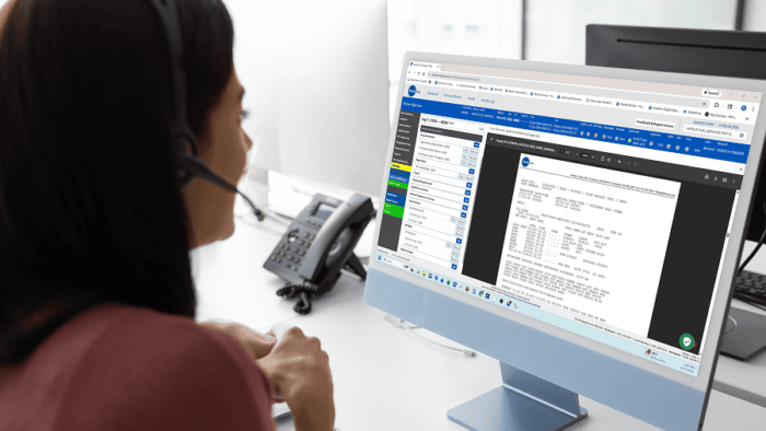 Person working at computer with headset.