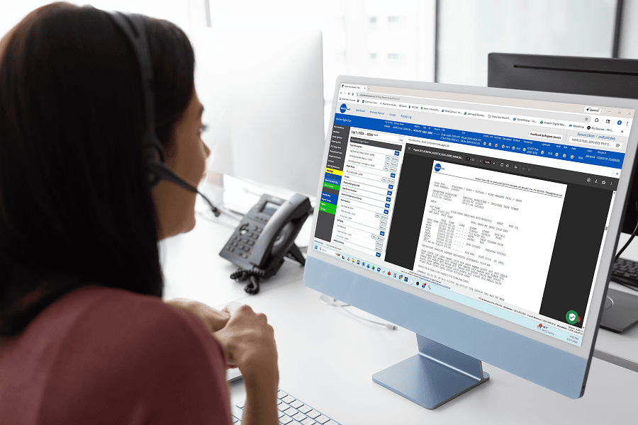 Person working at computer with headset.