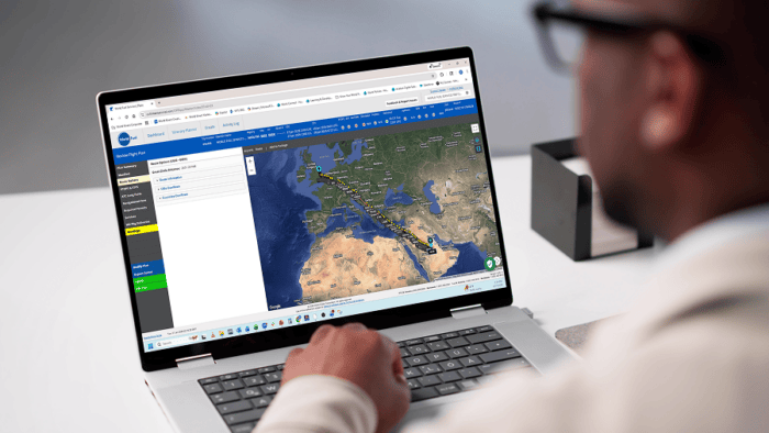 Person using laptop with map displayed