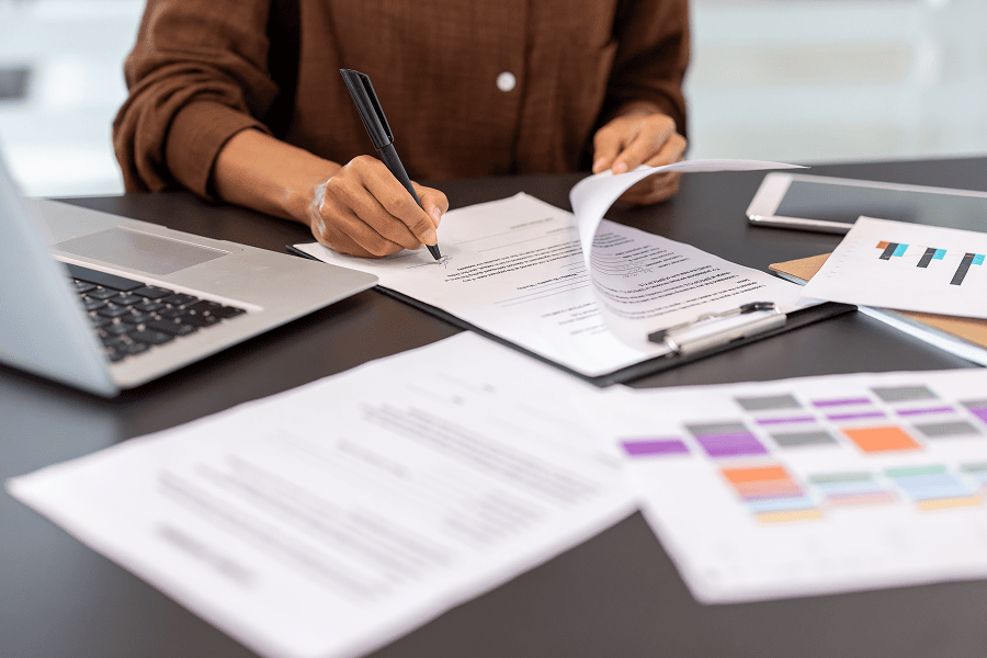 Signing documents at a business desk.