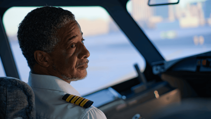 Pilot gazing thoughtfully from cockpit.