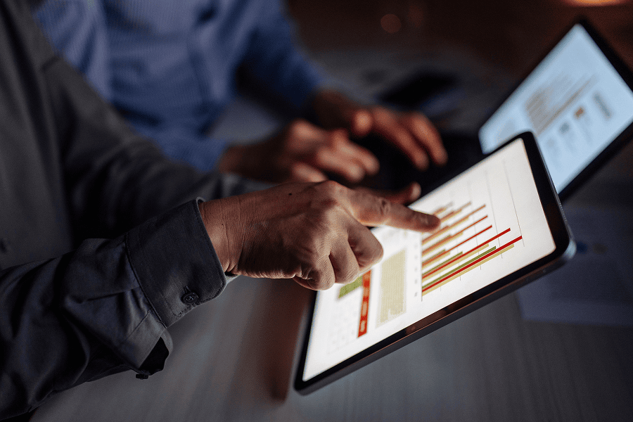 People looking over graphs in tablet