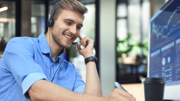 Smiling man with headset at desk