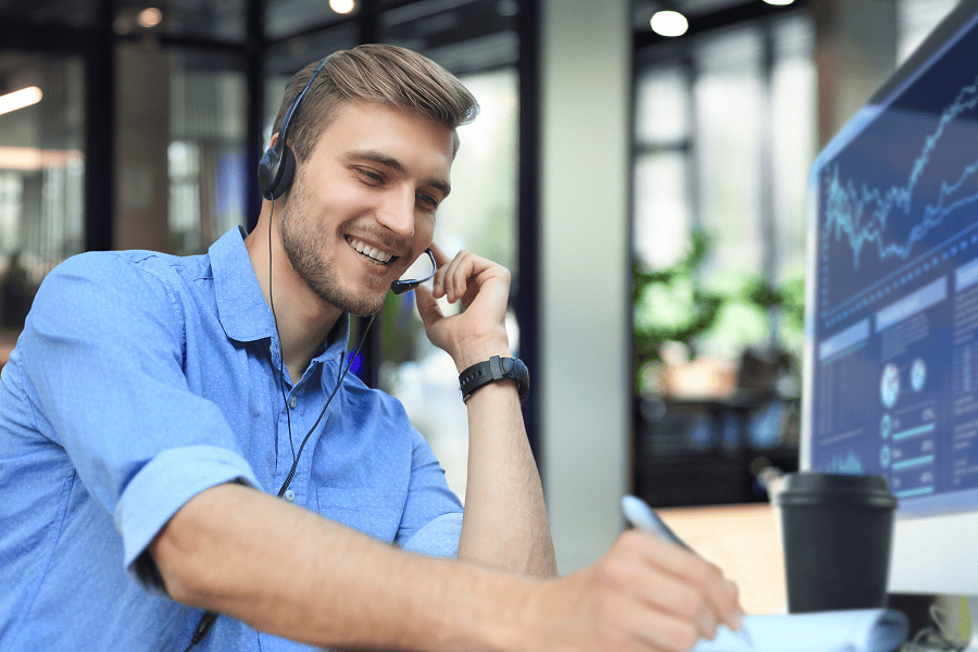 Smiling man with headset at desk