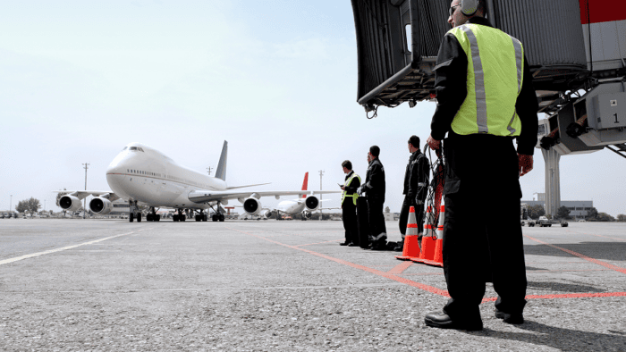 Ground crew awaiting an arriving aircraft.