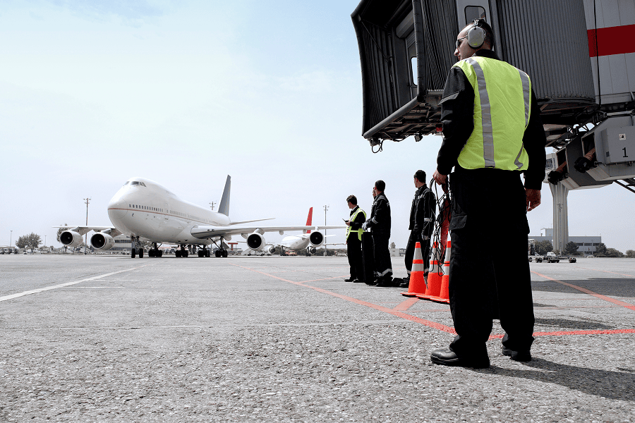 Ground crew awaiting an arriving aircraft.