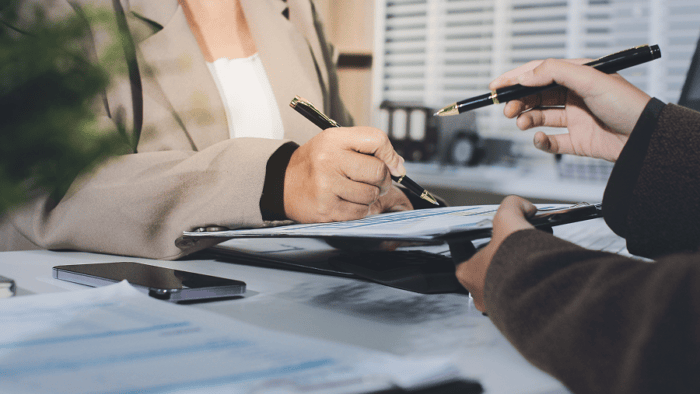Signing documents in a professional setting.