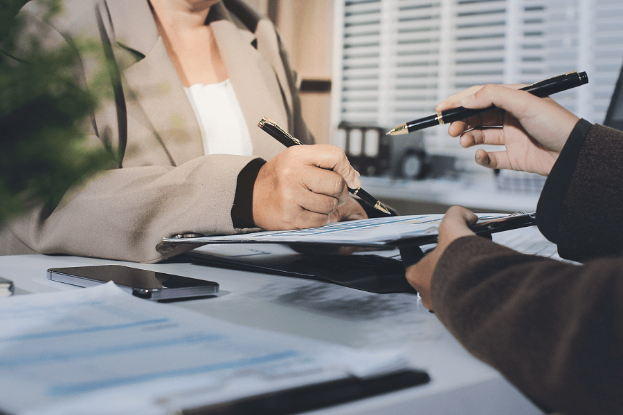 Signing documents in a professional setting.