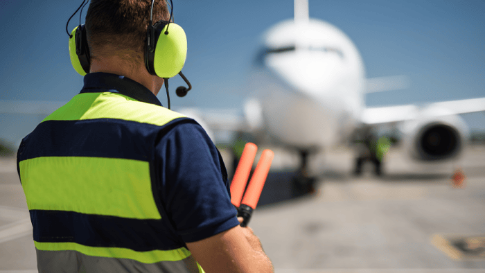 Aviation marshaller directing a jet.