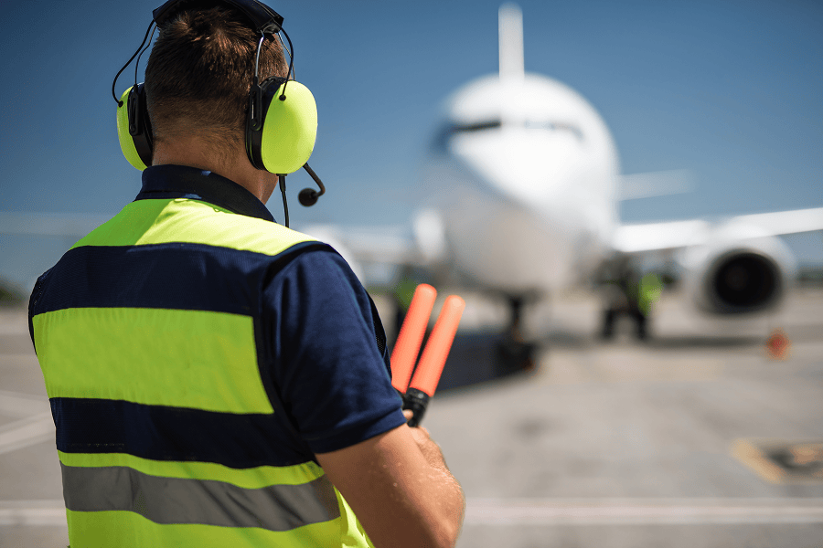 Aviation marshaller directing a jet.