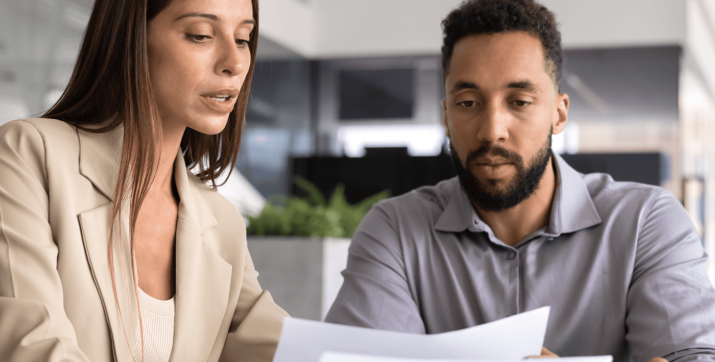 Two professionals discussing financial documents.