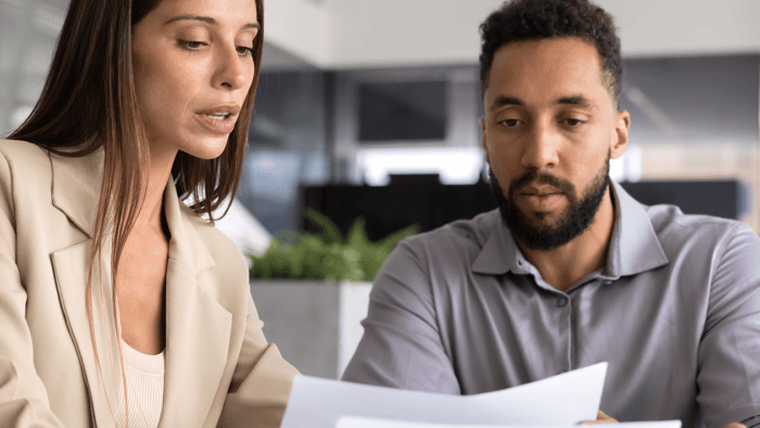 Two professionals discussing financial documents.