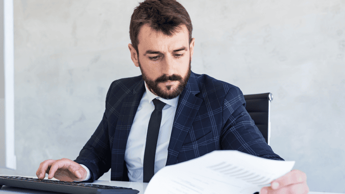 Man reviewing documents at desk.