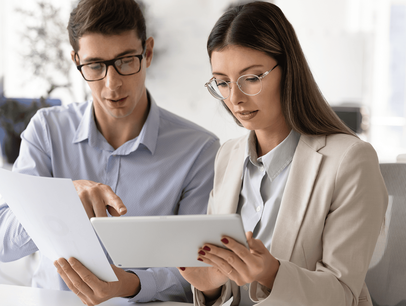 Business discussion with documents and tablet.
