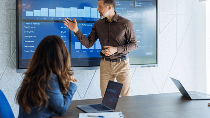 Man presenting data to colleagues.