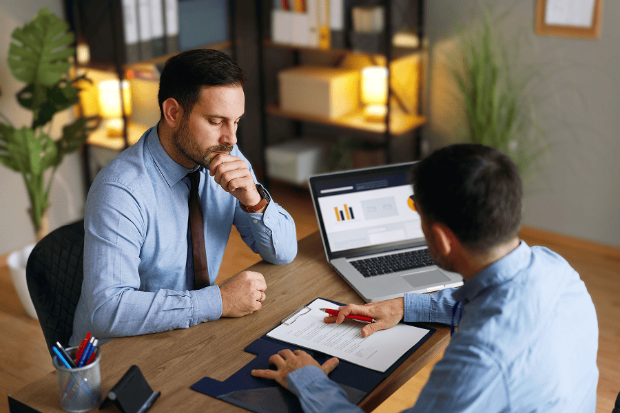 two men looking over document
