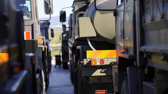 A detailed close-up of heavy logistics vehicles and tactical fuel tankers parked at a defense supply facility