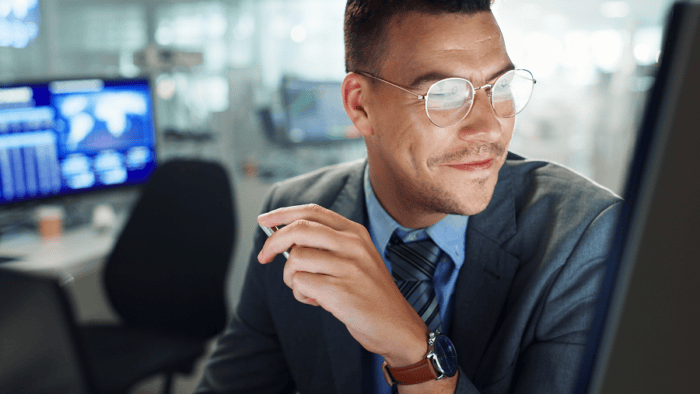 Smiling businessman working at computer.