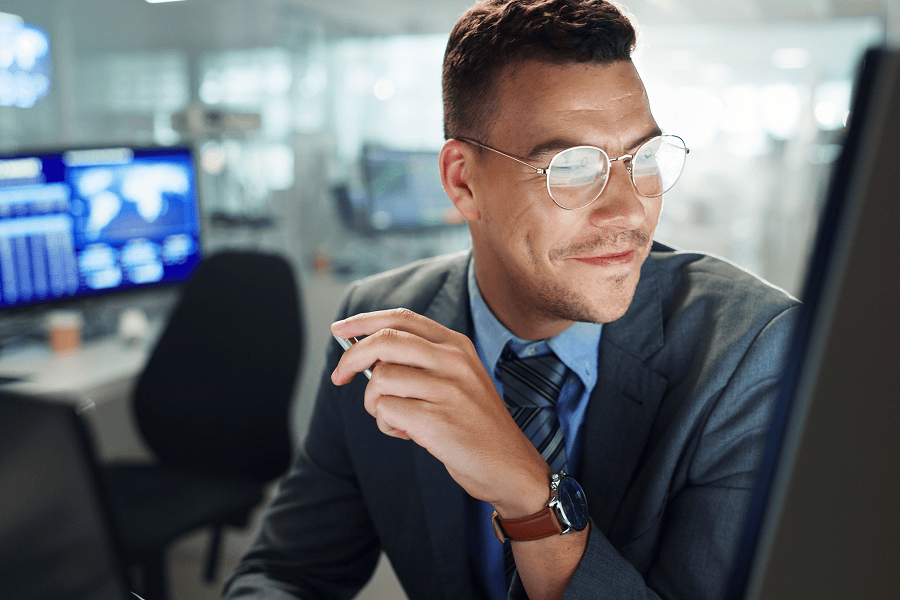 Smiling businessman working at computer.