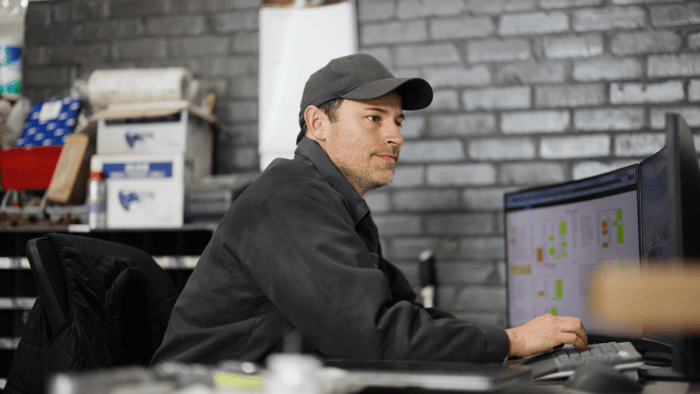 man sits at computer