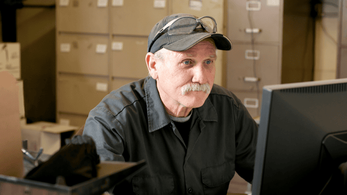 man sits at computer