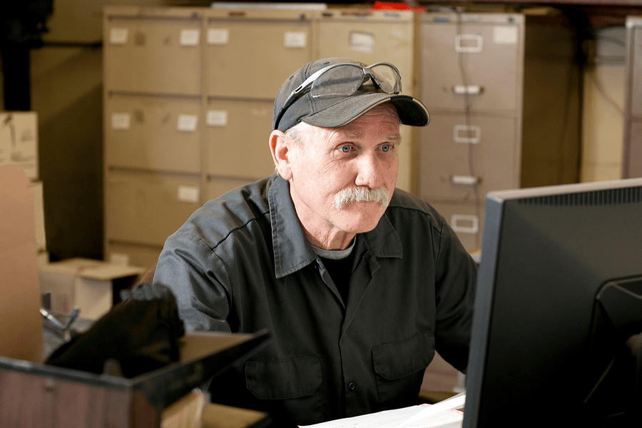 man sits at computer