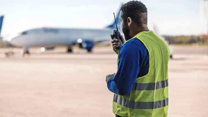 Airport worker using radio communication.