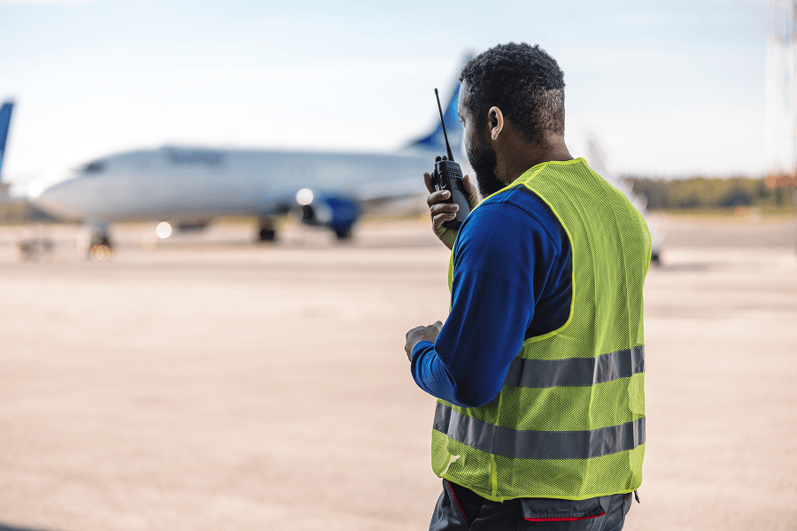 Airport worker using radio communication.
